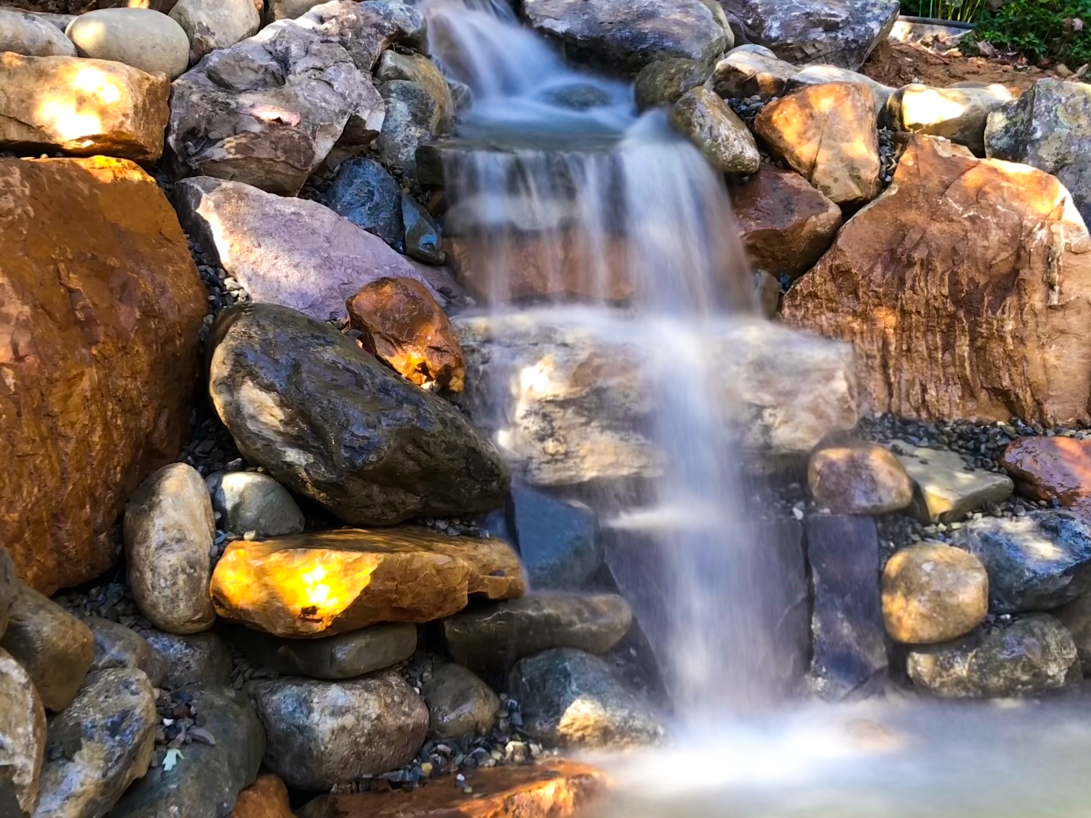 A waterfall is shown with rocks and water.